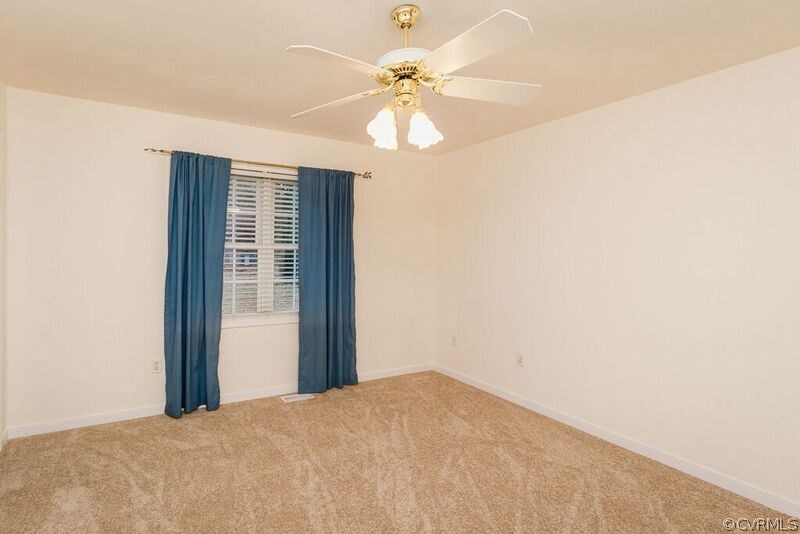 6037 Springbank Road Petersburg, VA 23803 - Photo 9 of 15 a view of a bedroom with a ceiling fan and a window