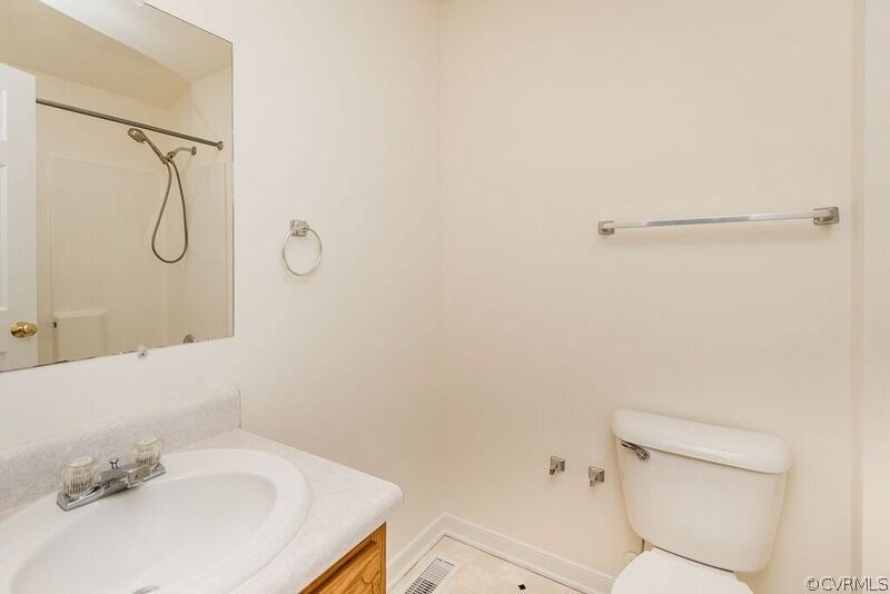 6037 Springbank Road Petersburg, VA 23803 - Photo 10 of 15 a bathroom with a sink a toilet and shower