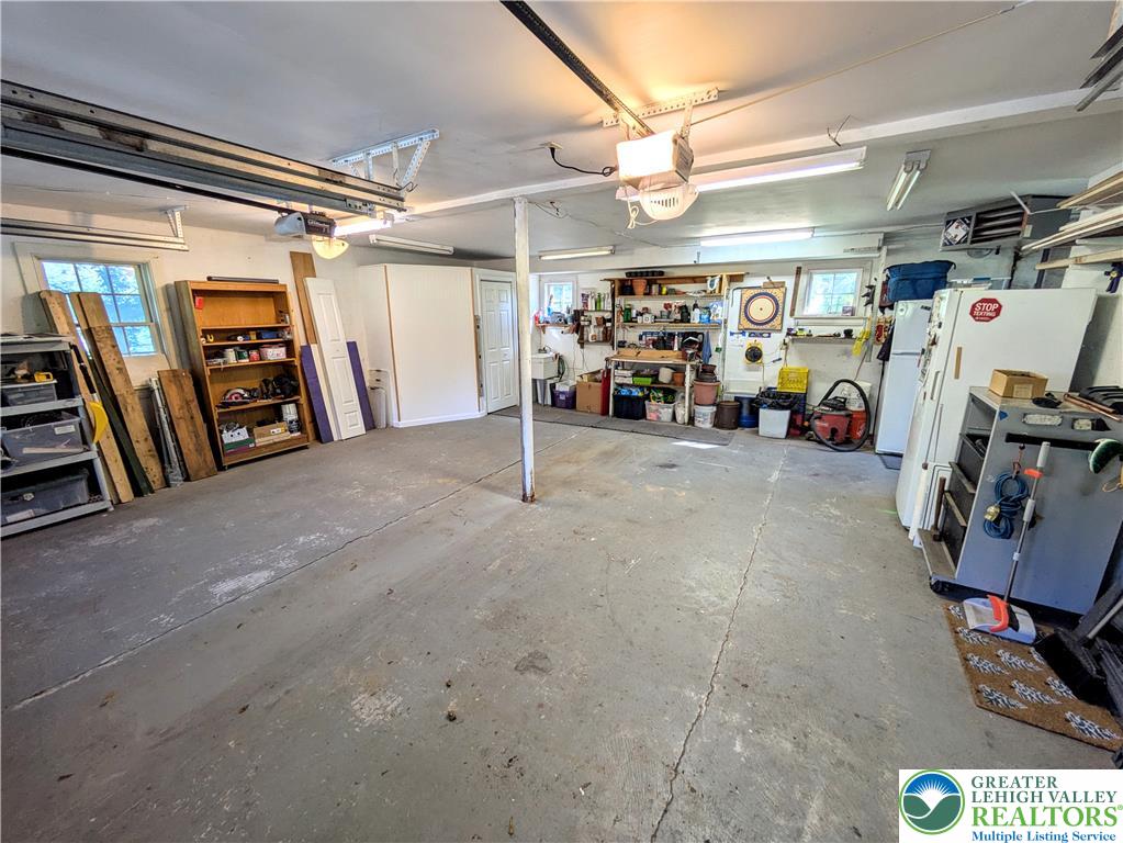 1731 Howell Road Easton, PA 18040 - Photo 31 of 60 An expansive concrete floor anchors this functional workspace with built-in storage and bright overhead lighting.
