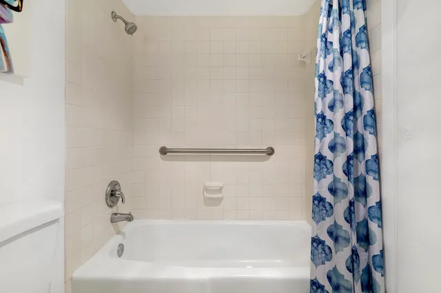 a bathroom with bathtub and shower