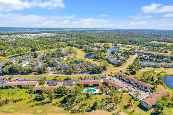 an aerial view of residential building and lake