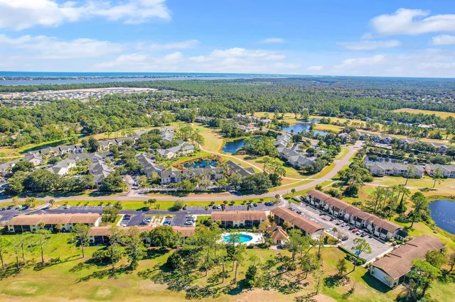 an aerial view of residential building and lake