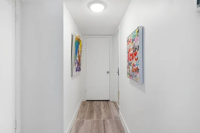 a view of an entryway with wooden floor
