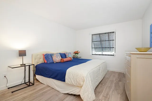 a bed room with two beds and a window