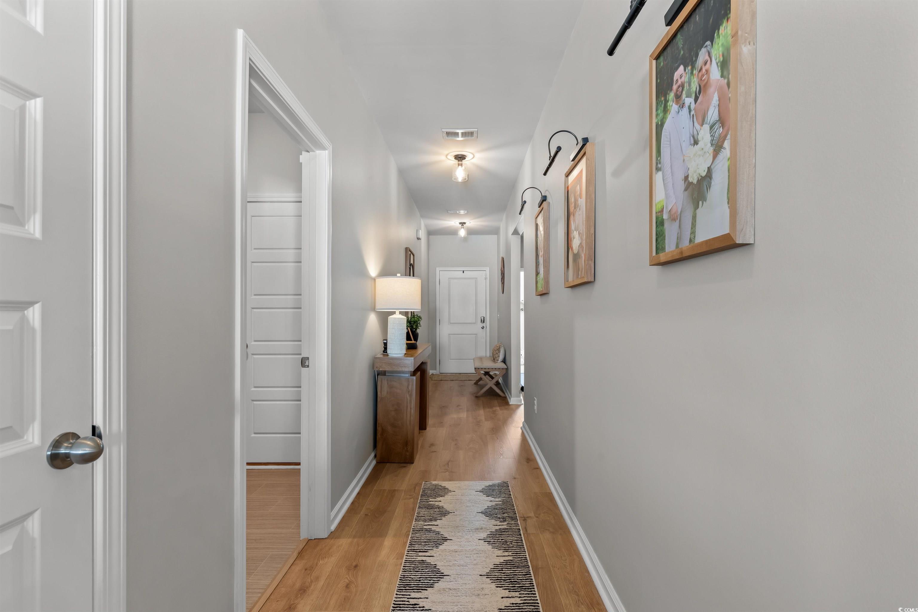 1067 Saltgrass Way Myrtle Beach, SC 29588 - Photo 14 of 40 Hall featuring light wood-type flooring and baseboards
