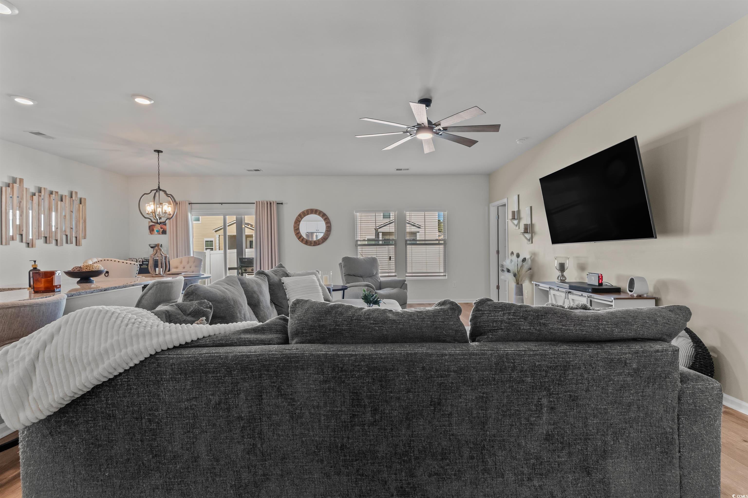 1067 Saltgrass Way Myrtle Beach, SC 29588 - Photo 15 of 40 Living room featuring light wood-style flooring, recessed lighting, a chandelier, and ceiling fan