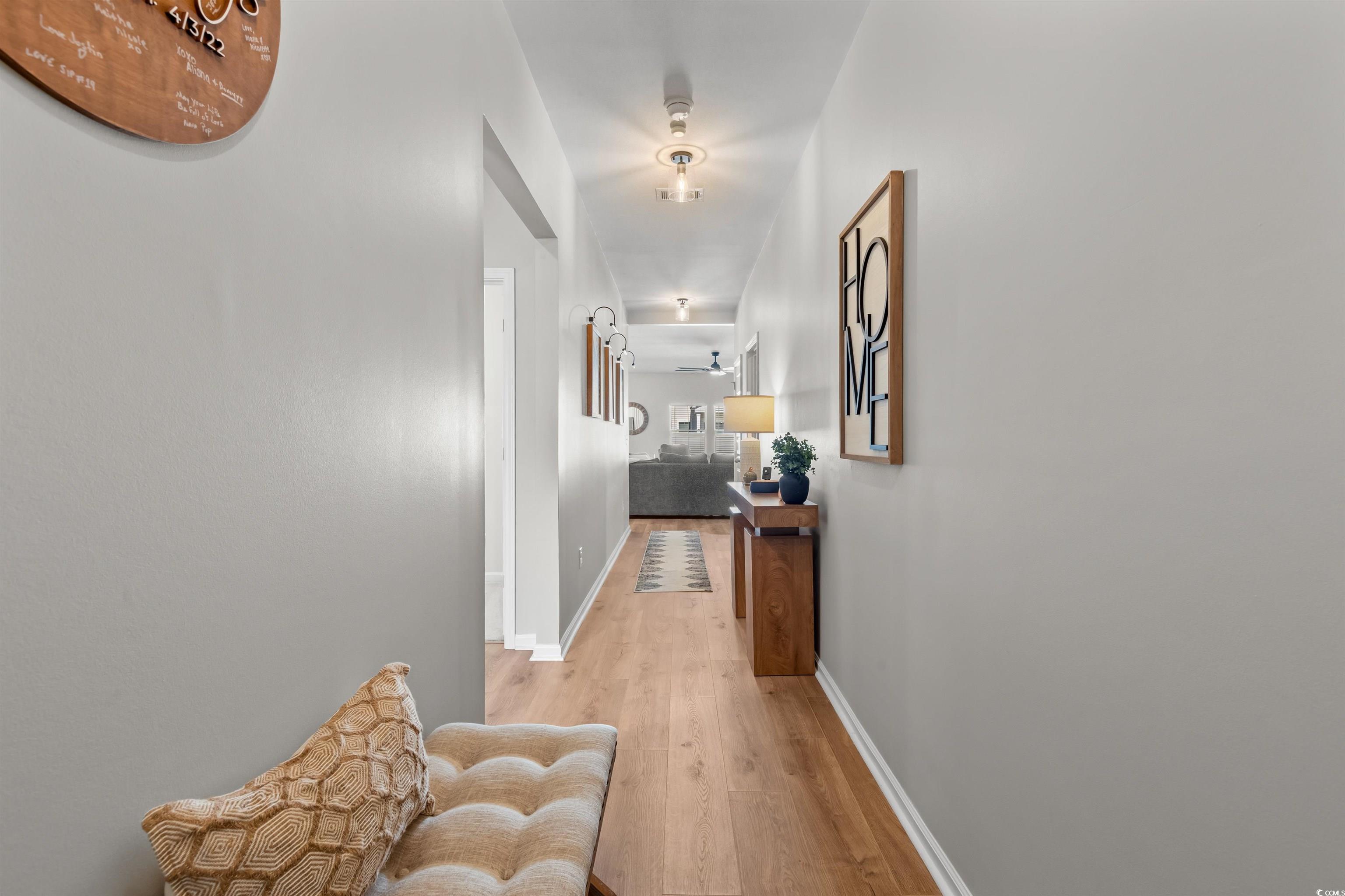 1067 Saltgrass Way Myrtle Beach, SC 29588 - Photo 2 of 40 Hallway featuring light wood-style floors and baseboards