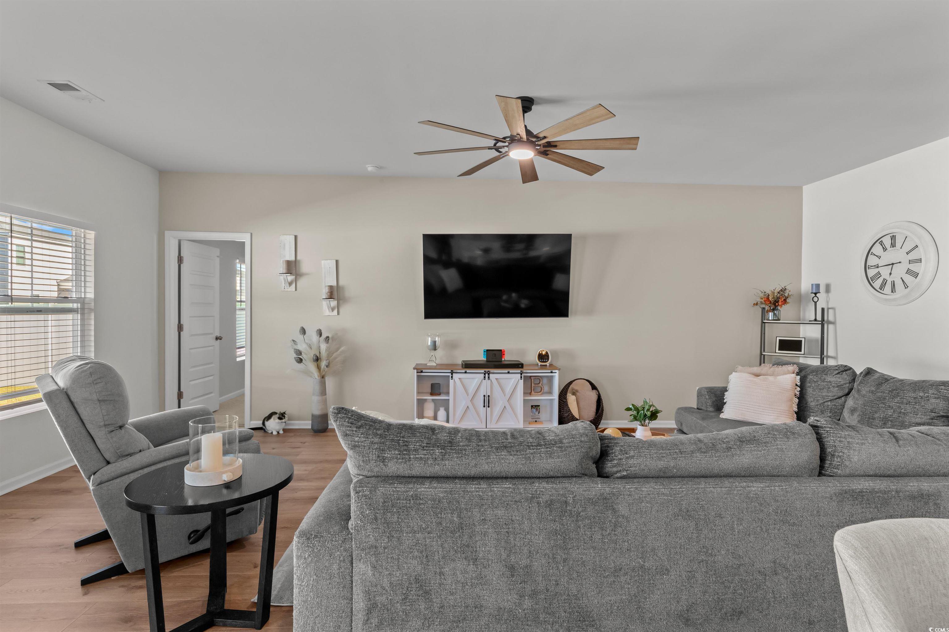 1067 Saltgrass Way Myrtle Beach, SC 29588 - Photo 26 of 40 Living room with wood finished floors and ceiling fan