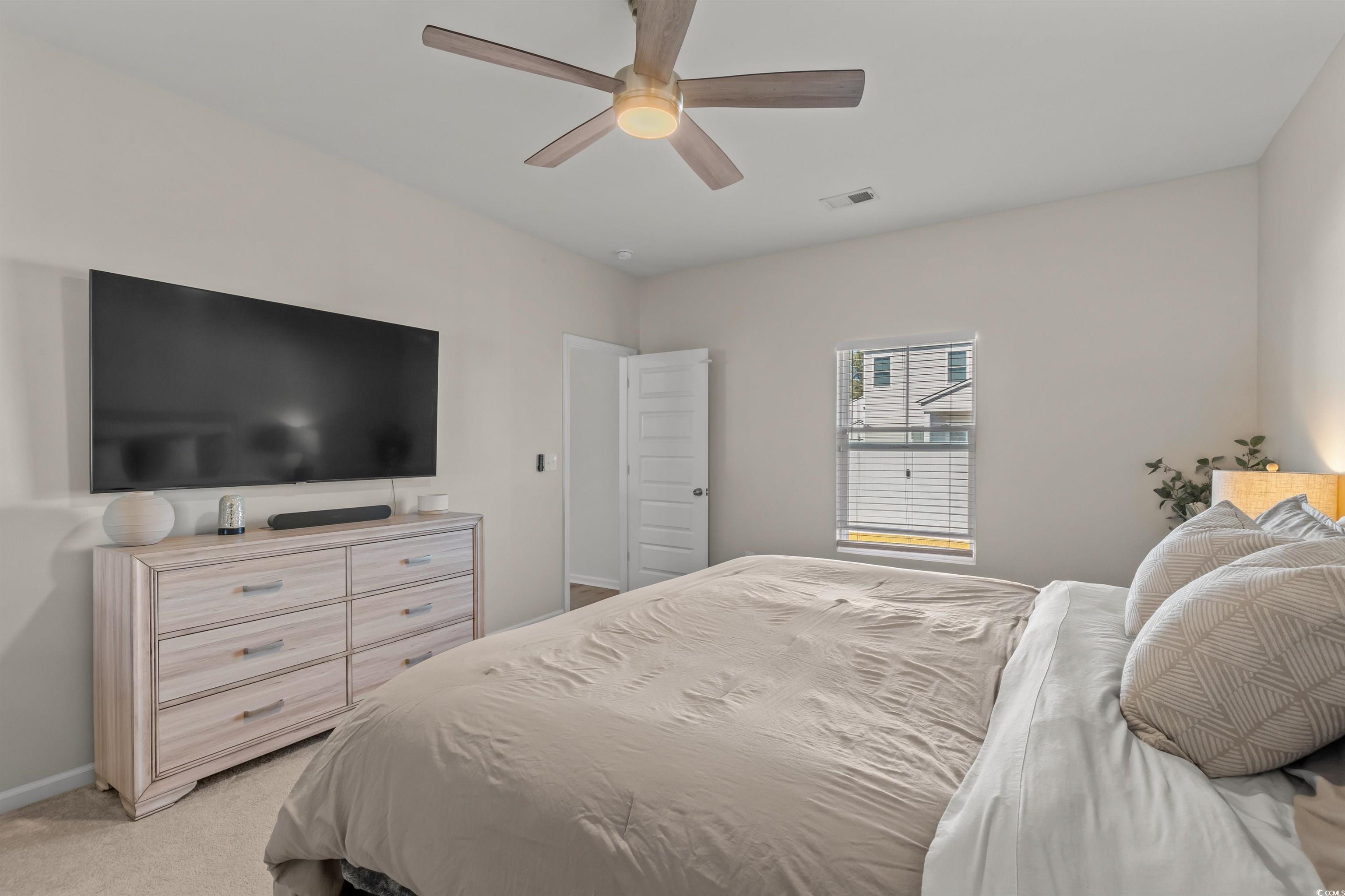 1067 Saltgrass Way Myrtle Beach, SC 29588 - Photo 30 of 40 Bedroom with light carpet and a ceiling fan