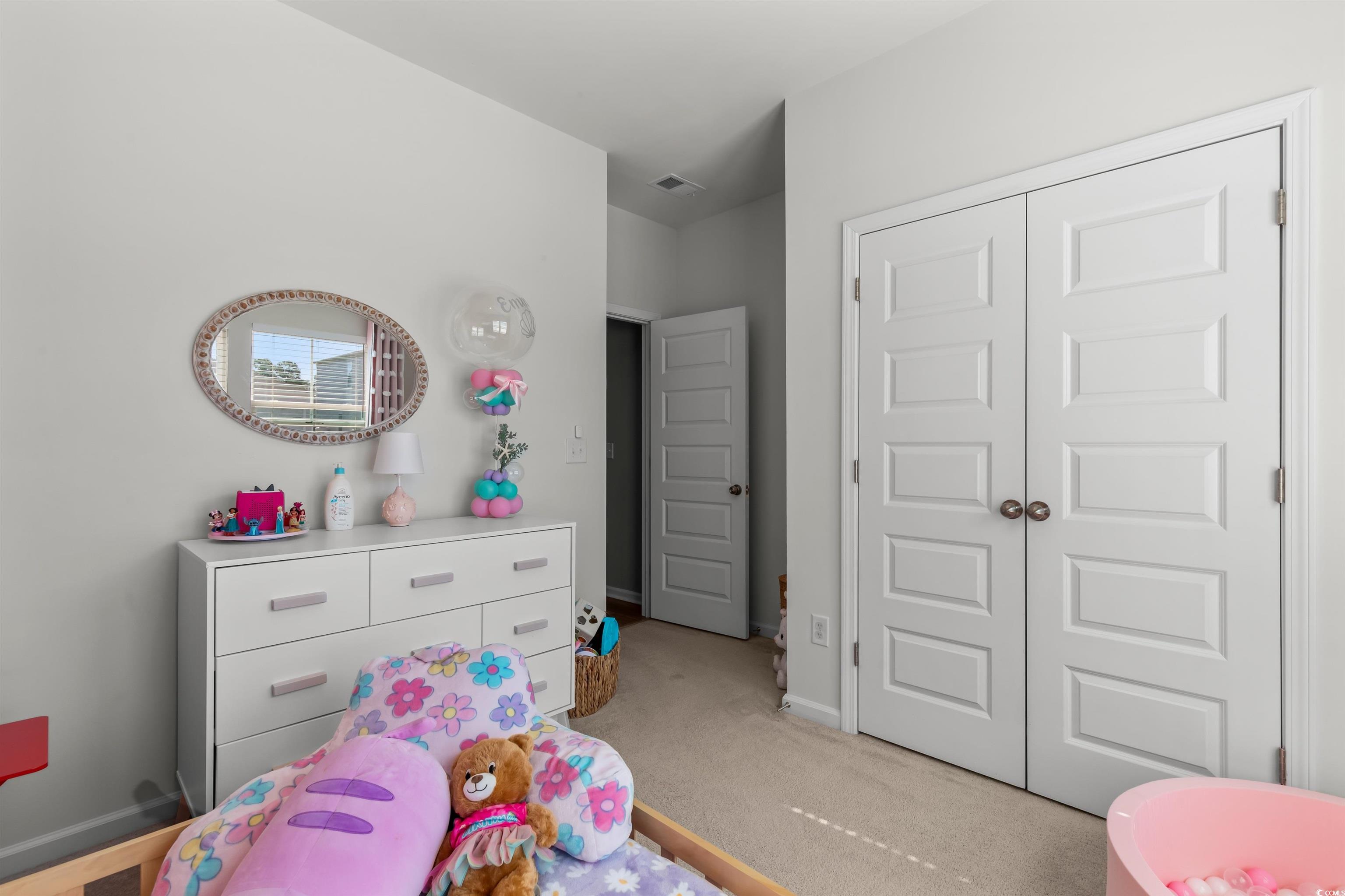 1067 Saltgrass Way Myrtle Beach, SC 29588 - Photo 6 of 40 Bedroom featuring light colored carpet and a closet