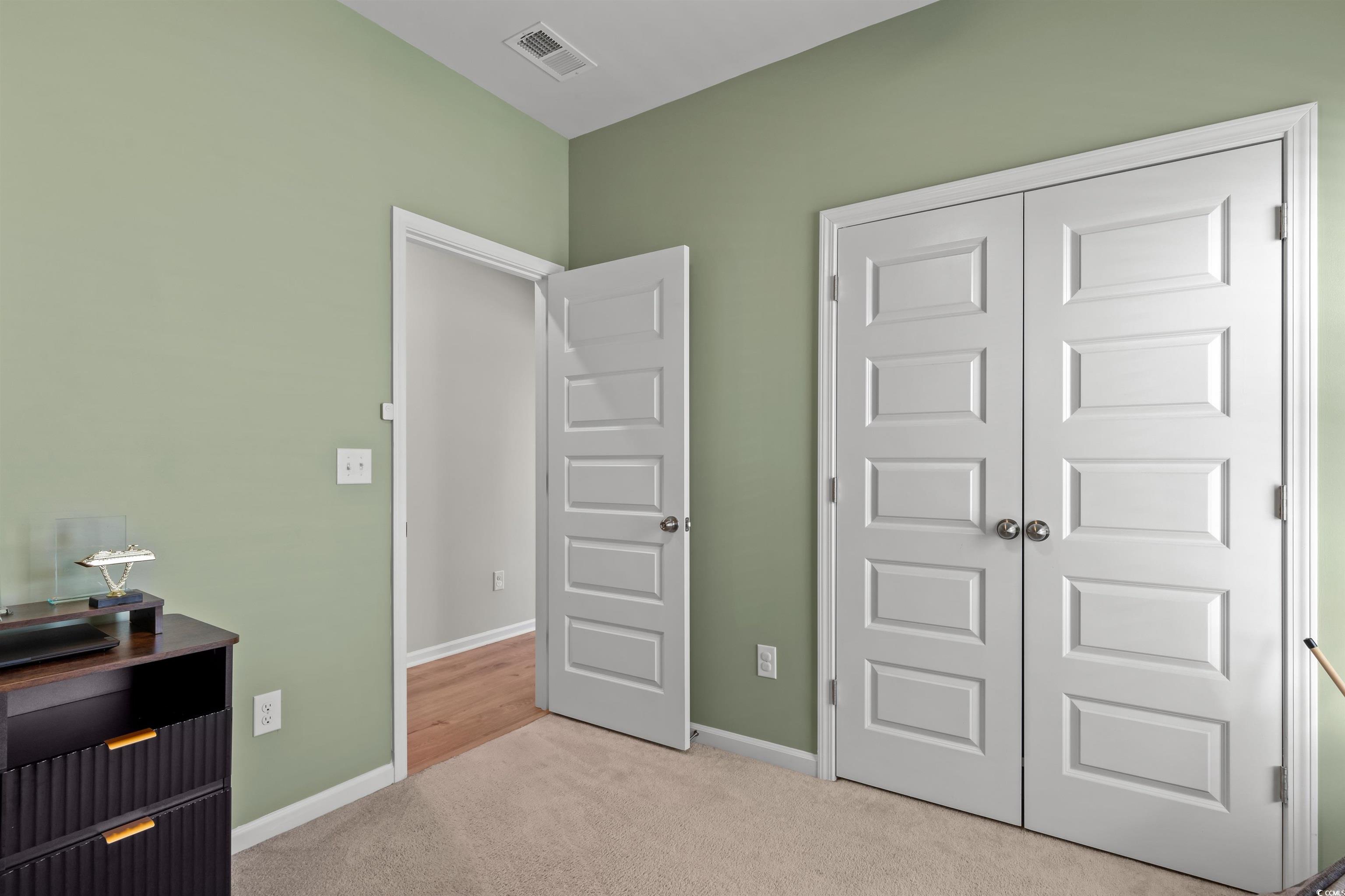 1067 Saltgrass Way Myrtle Beach, SC 29588 - Photo 10 of 40 Bedroom with light carpet and a closet