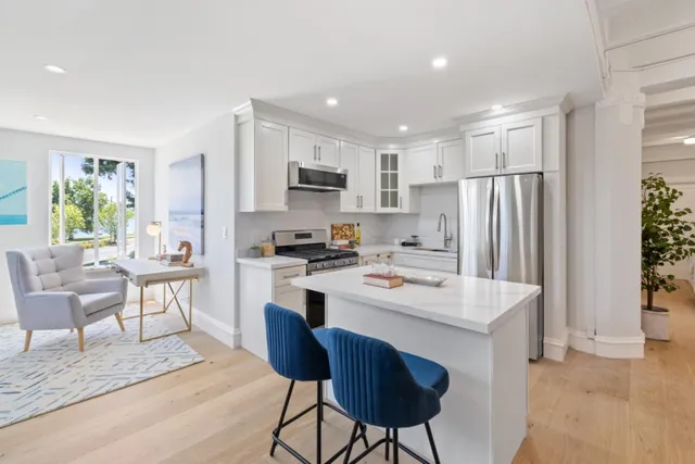 a kitchen with kitchen island a stove a sink and a refrigerator