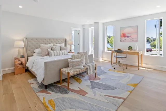 a bedroom with a bed and wooden floor