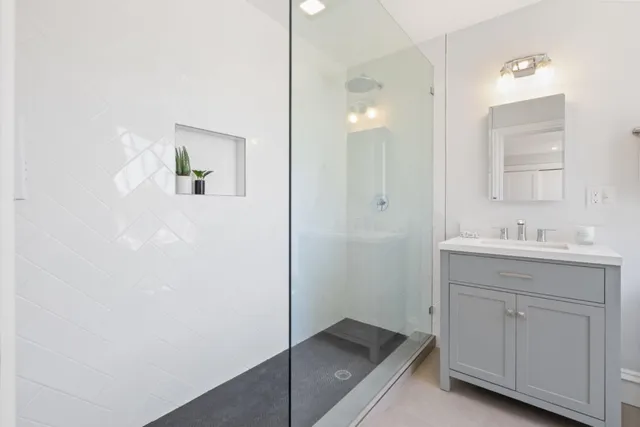 a bathroom with a sink a toilet and shower