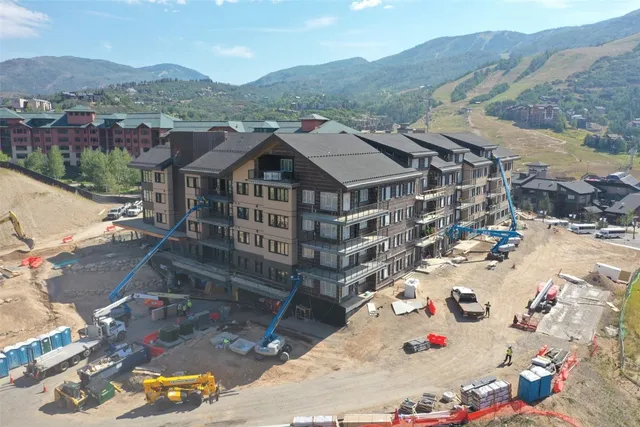 an aerial view of a house with a mountain