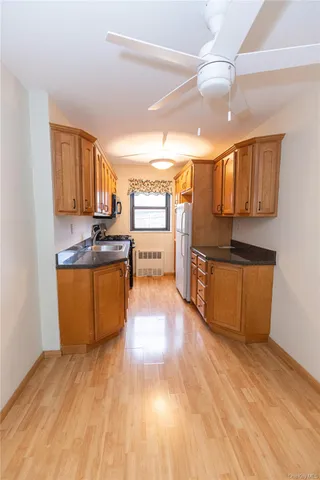 a view of a kitchen with a sink and cabinets