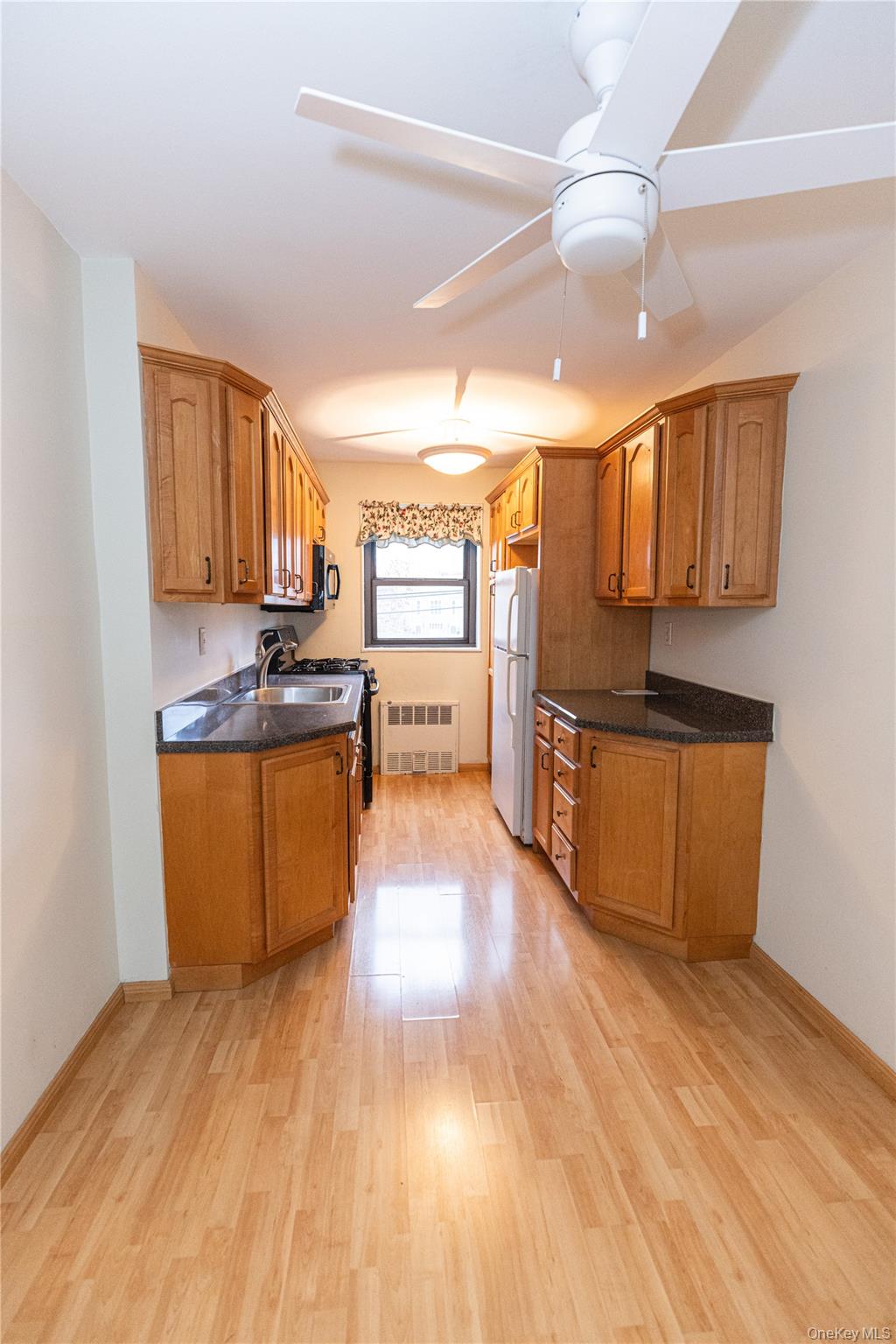 266 Pelham Road, Unit 4H New Rochelle, NY 10805 - Photo 5 of 13 a large kitchen with stainless steel appliances granite countertop a stove a sink and a refrigerator