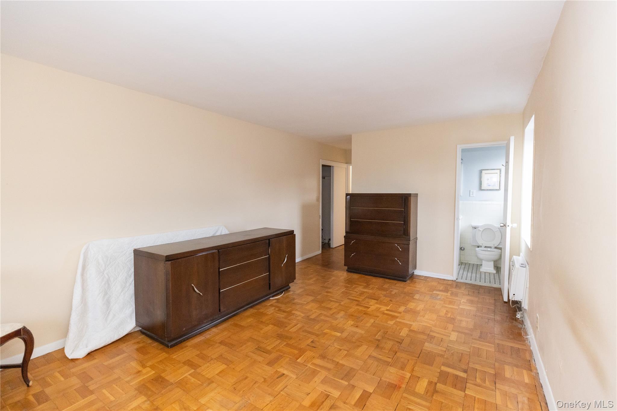 266 Pelham Road, Unit 4H New Rochelle, NY 10805 - Photo 7 of 13 a bedroom with a bed and cabinets