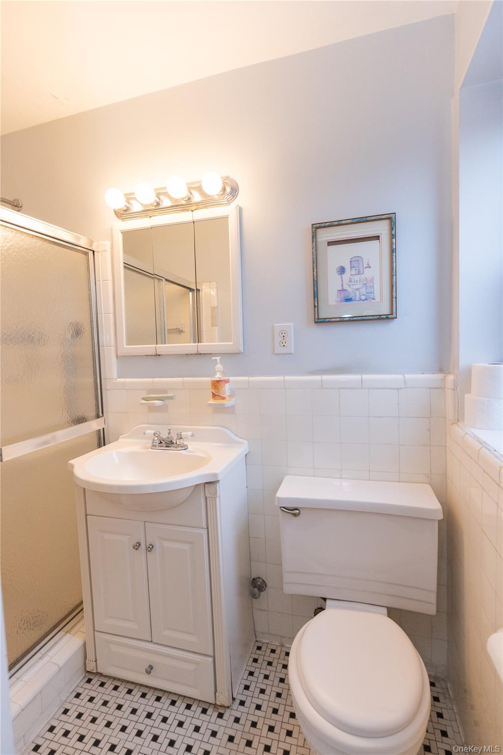 266 Pelham Road, Unit 4H New Rochelle, NY 10805 - Photo 8 of 13 a bathroom with a toilet a sink and a mirror