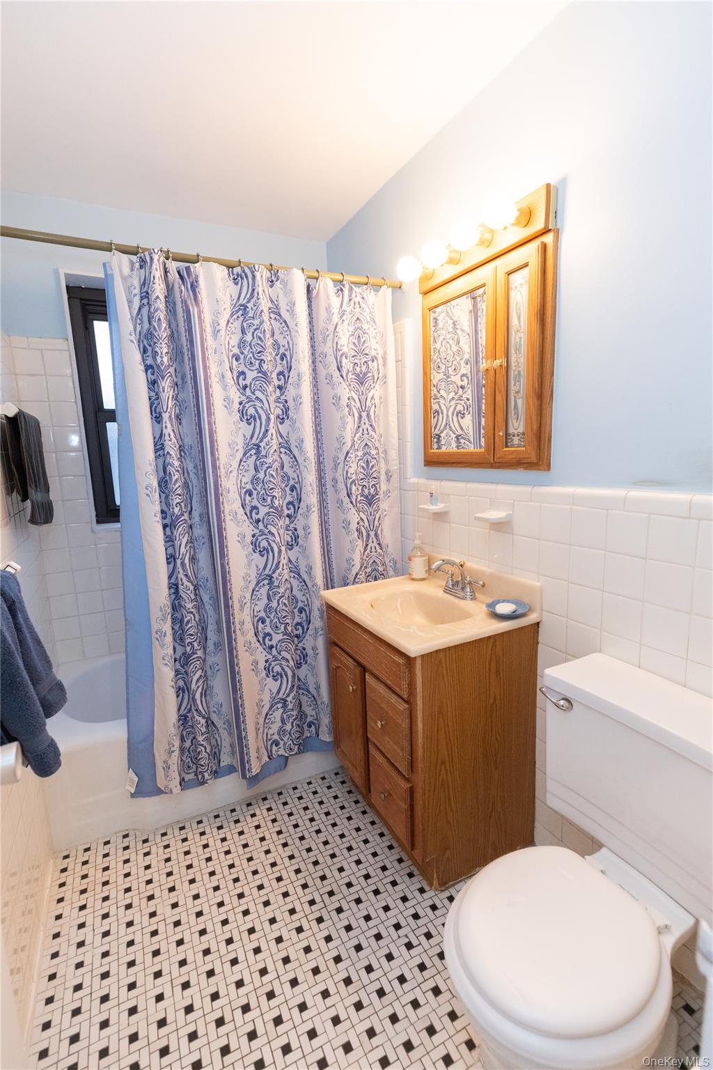 266 Pelham Road, Unit 4H New Rochelle, NY 10805 - Photo 9 of 13 a bathroom with a sink a toilet a mirror a vanity and shower