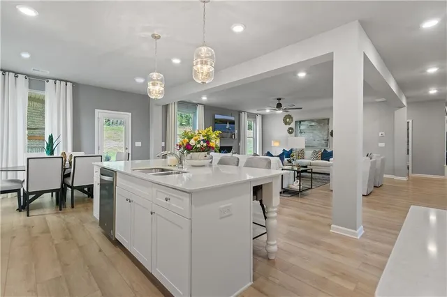 an open kitchen with a sink and breakfast area