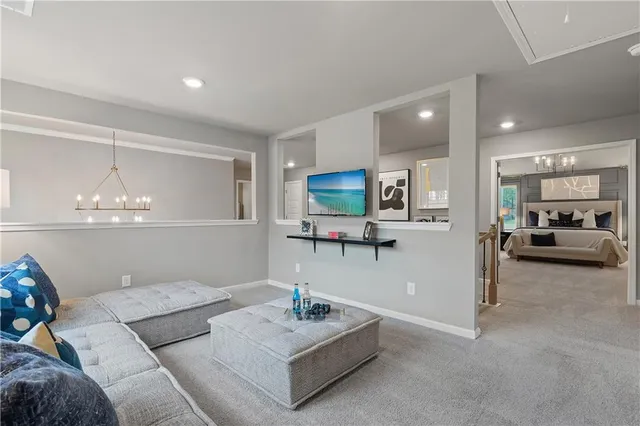 a living room with furniture and a chandelier
