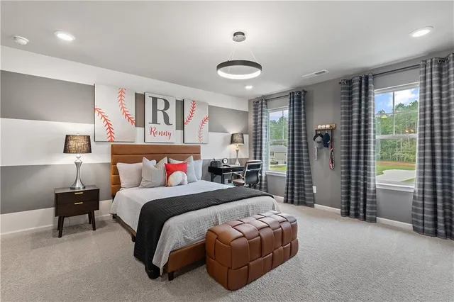 a bedroom with a large bed and a chandelier