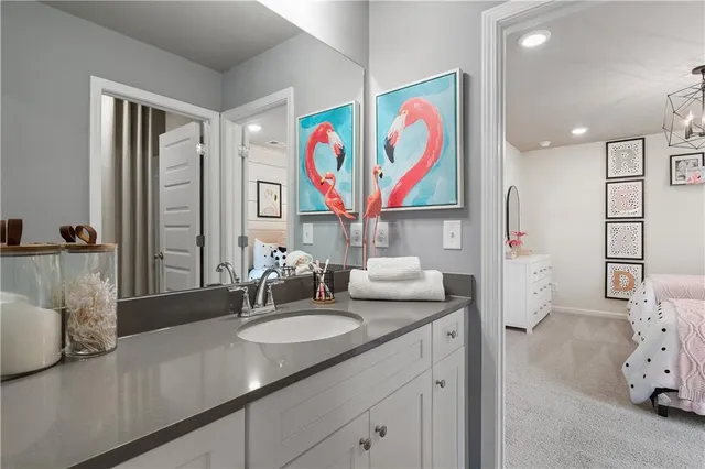 a bathroom with a sink mirror vanity and toilet