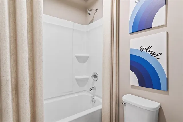 a bathroom with a bathtub and a toilet