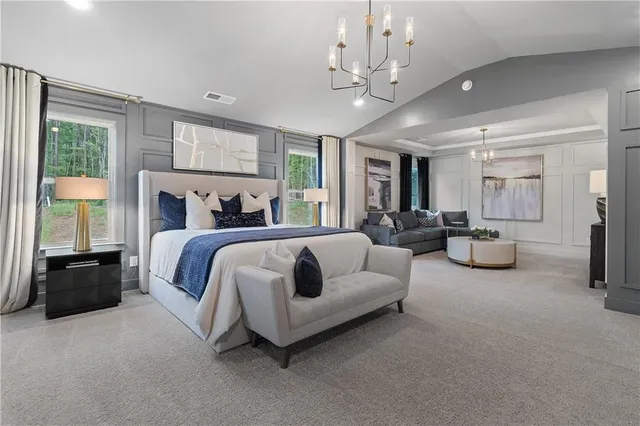 a spacious bedroom with bed and a chandelier