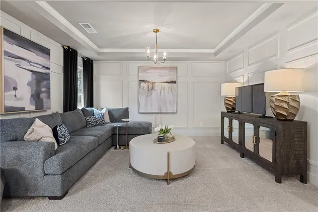 a living room with furniture and a chandelier