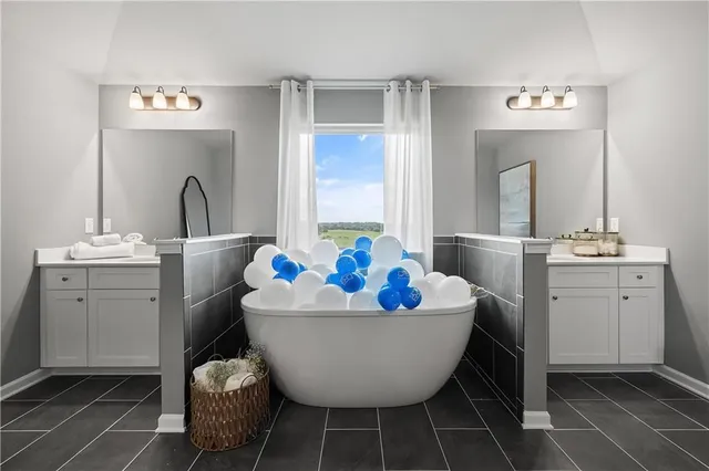 a room with a baby crib and a mirror