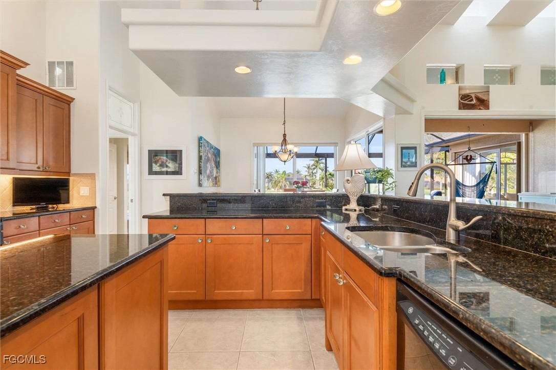 11768 Lady Anne Circle Cape Coral, FL 33991 - Photo 16 of 49 a kitchen with stainless steel appliances granite countertop sink stove top oven and cabinets