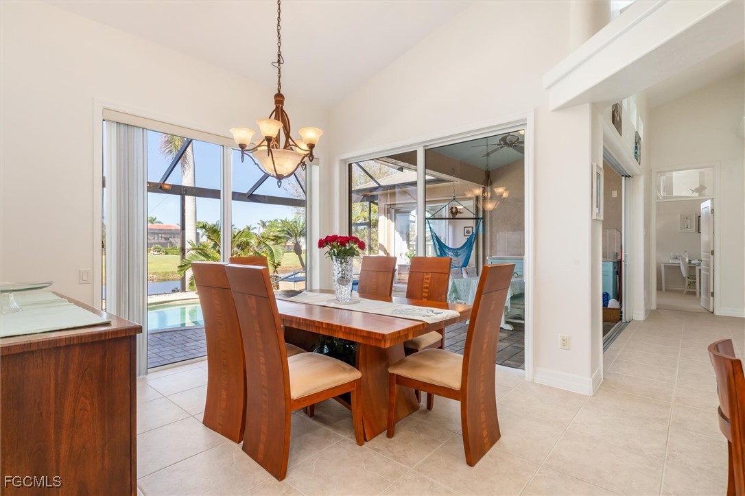 11768 Lady Anne Circle Cape Coral, FL 33991 - Photo 19 of 49 a dining room with furniture a chandelier and window