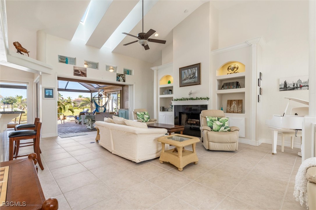 11768 Lady Anne Circle Cape Coral, FL 33991 - Photo 5 of 49 a living room with furniture and a fireplace