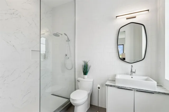 a bedroom with bed and a painting on the wall