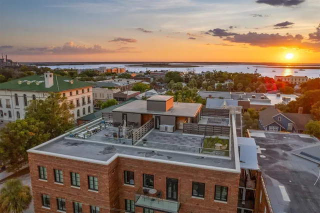 a view of a city with lawn chairs and wooden floor
