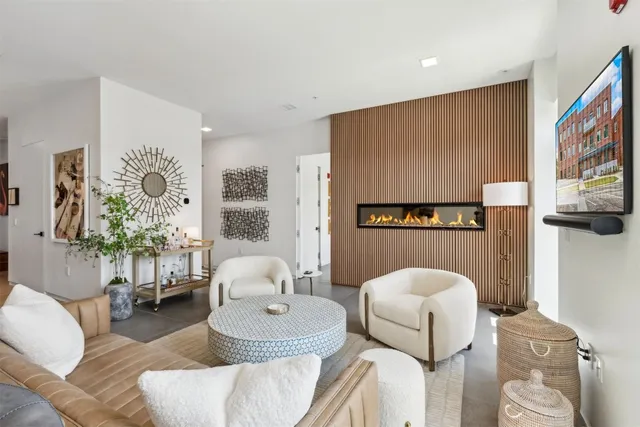 a living room with furniture and a painting on the wall