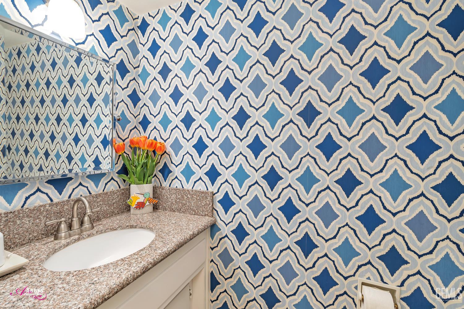 Undisclosed Address Bakersfield, CA 93309 - Photo 13 of 30 a bathroom with a granite countertop sink and a mirror