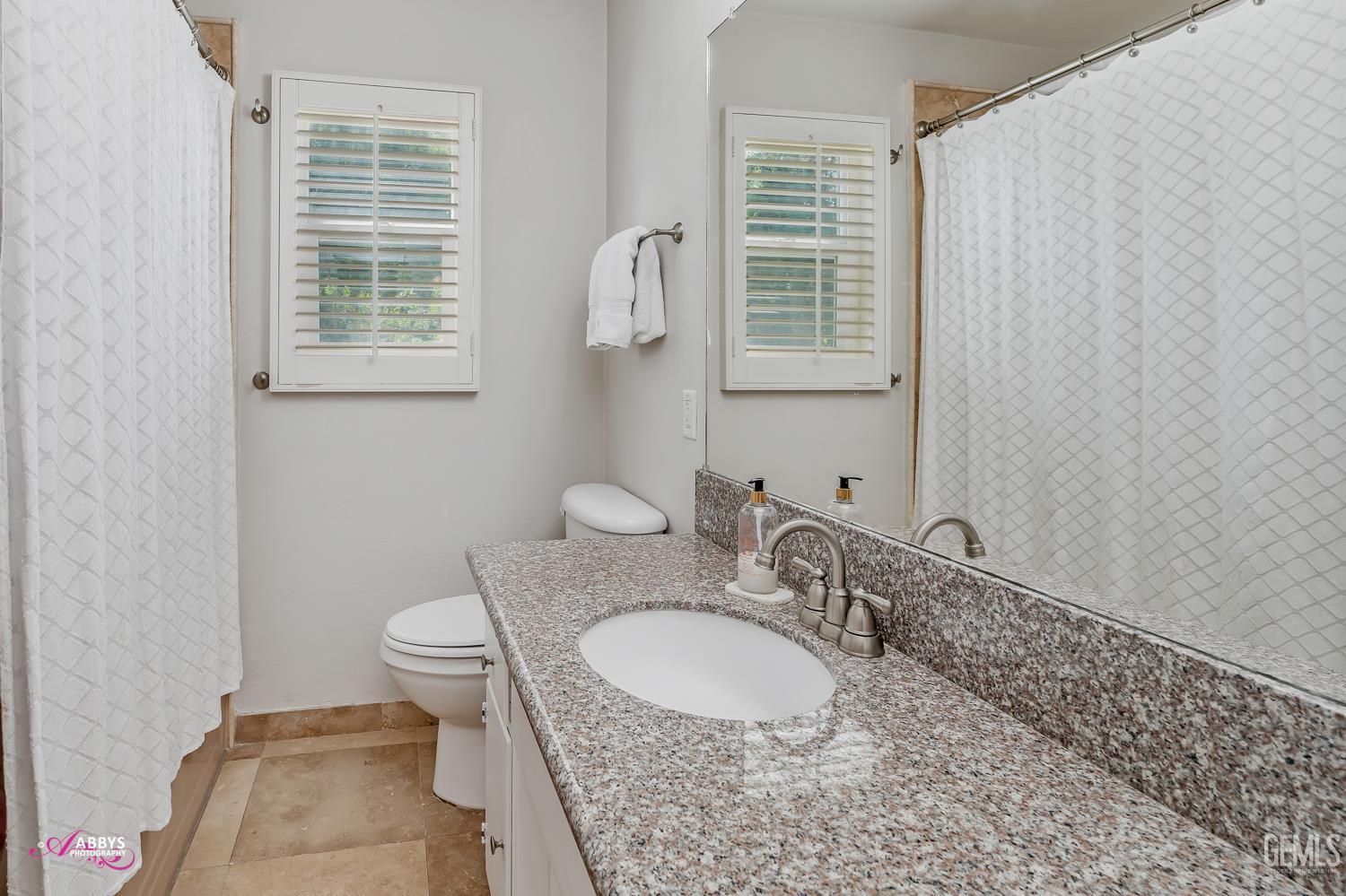 Undisclosed Address Bakersfield, CA 93309 - Photo 18 of 30 a bathroom with a sink a toilet and a mirror