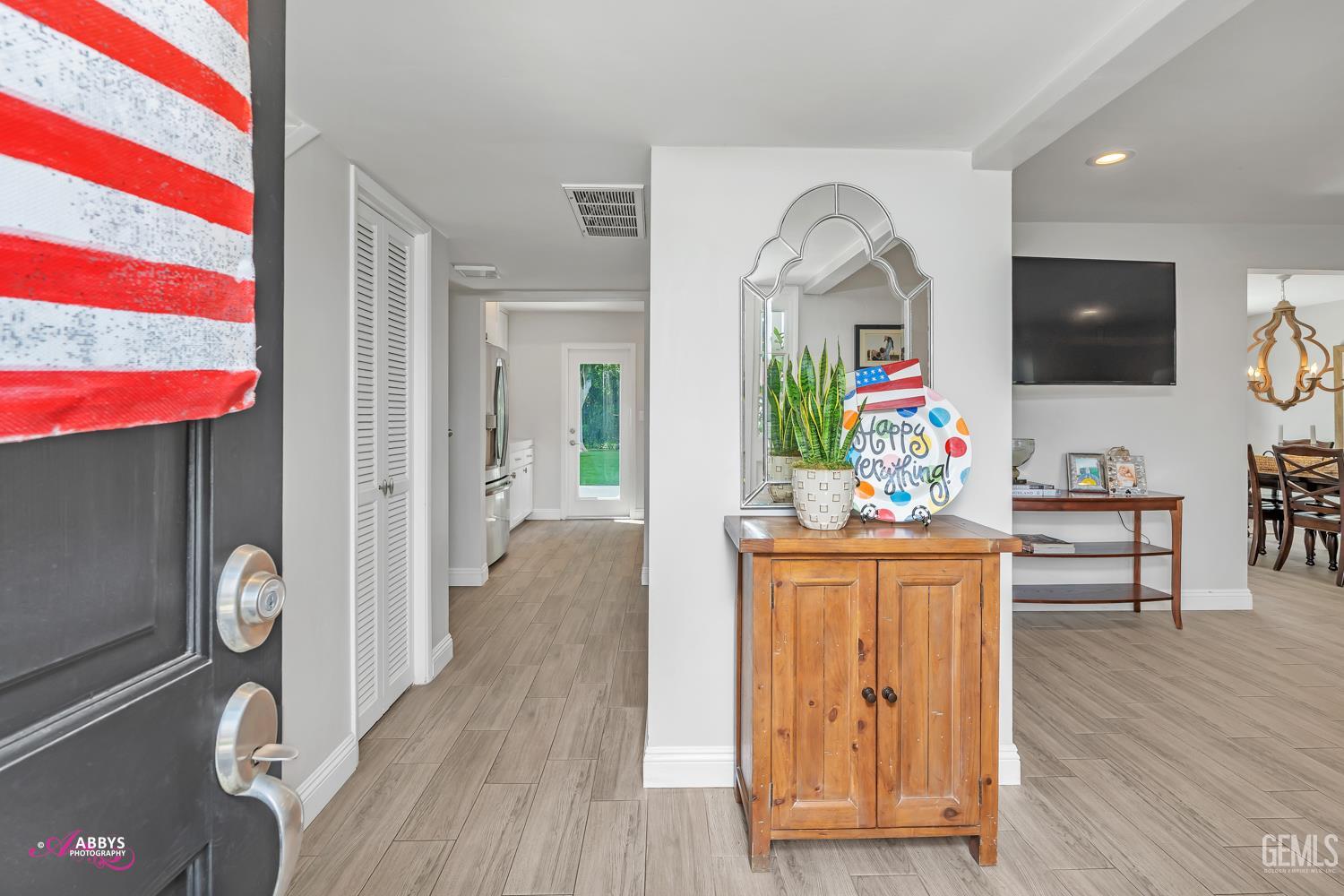 Undisclosed Address Bakersfield, CA 93309 - Photo 2 of 30 a view of living room with wooden floor furniture and flat screen tv