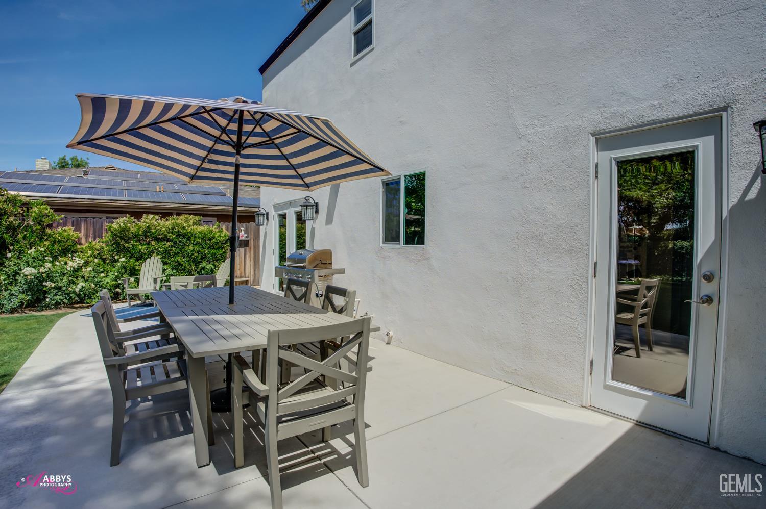 Undisclosed Address Bakersfield, CA 93309 - Photo 26 of 30 a view of a patio with table and chairs under an umbrella