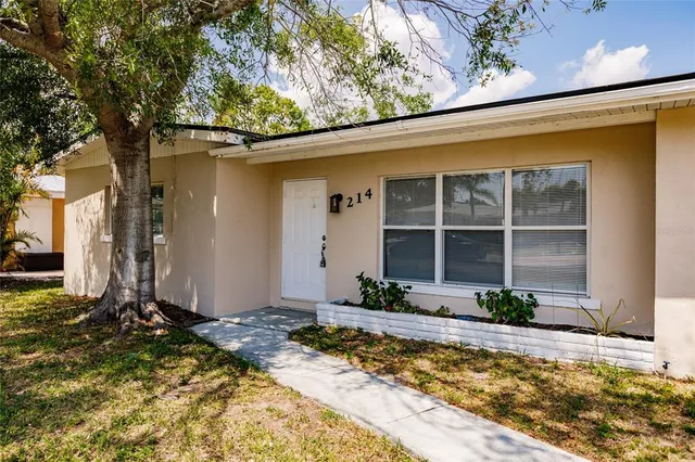 a front view of a house with a yard outdoor seating and garage