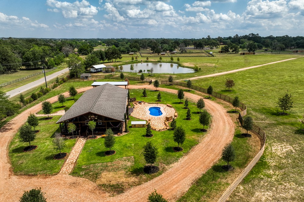 35418 Tompkins Road Hempstead, TX 77445 - Photo 2 of 50 a view of swimming pool with outdoor seating and garden