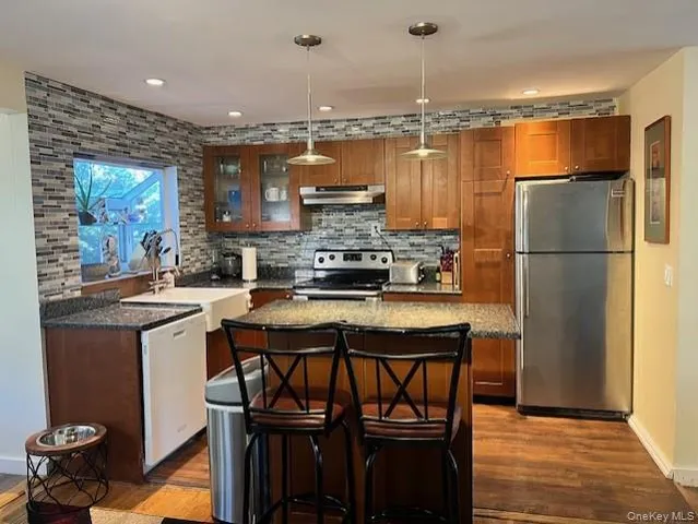 a kitchen with a refrigerator a sink and a stove