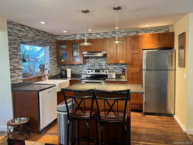 16 Lilac Road Westhampton Beach, NY 11978 - Photo 13 of 25 a kitchen with a refrigerator a sink and a stove