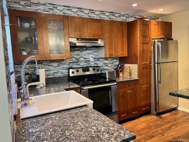 16 Lilac Road Westhampton Beach, NY 11978 - Photo 14 of 25 a kitchen with stainless steel appliances granite countertop a refrigerator a stove and a sink