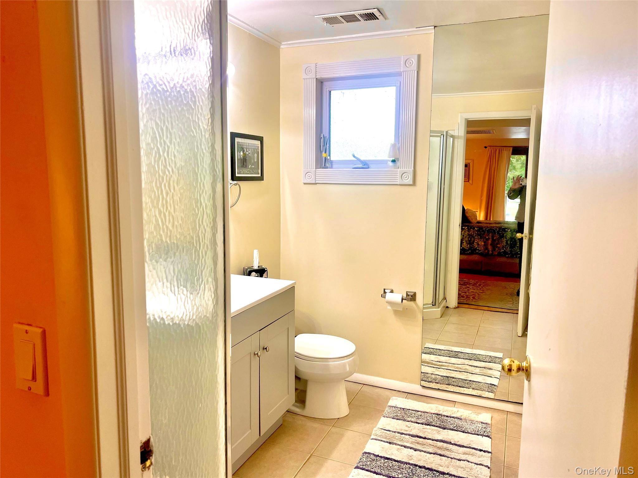 16 Lilac Road Westhampton Beach, NY 11978 - Photo 18 of 25 a bathroom with a sink and a toilet