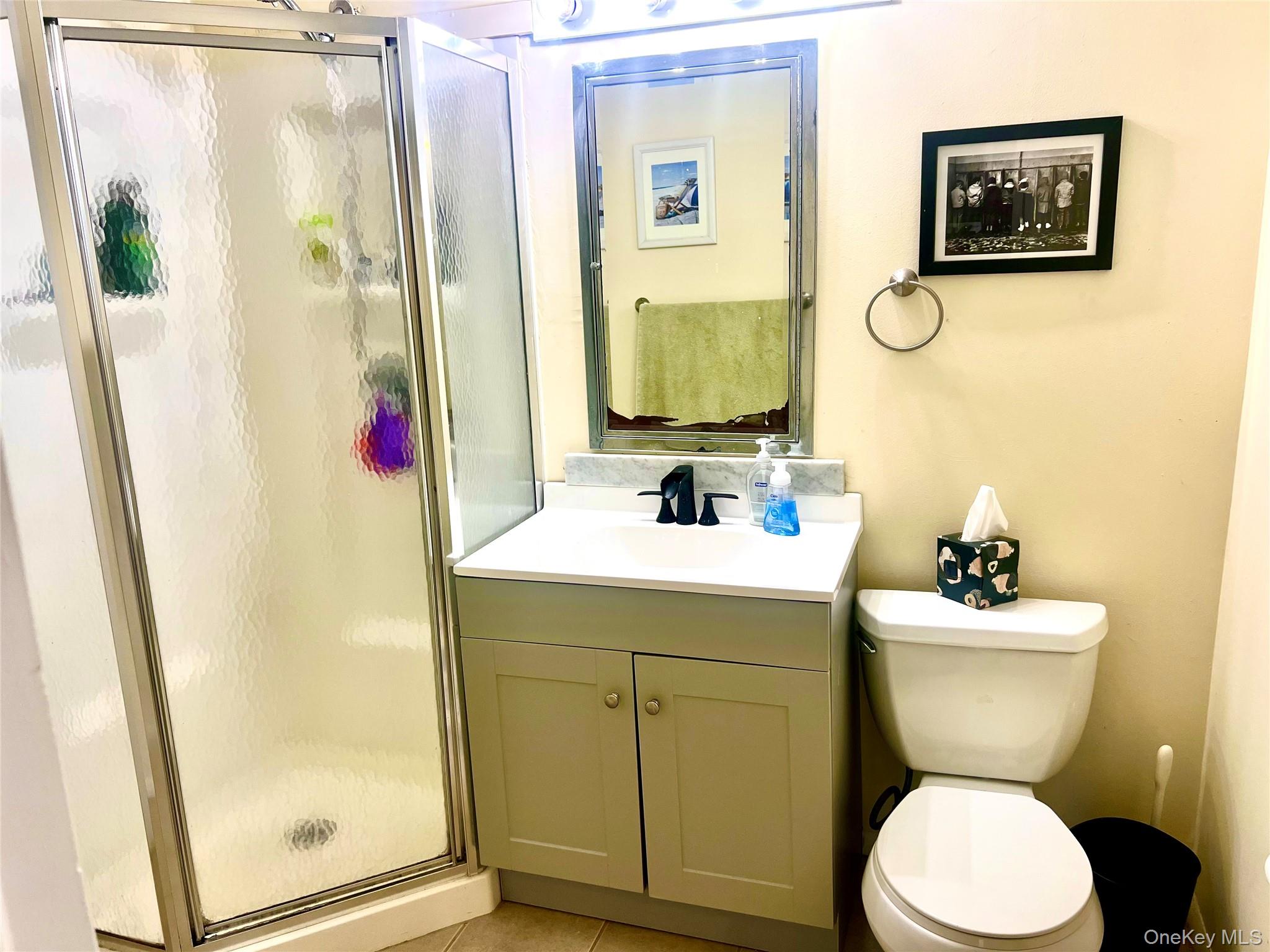 16 Lilac Road Westhampton Beach, NY 11978 - Photo 19 of 25 a bathroom with a sink mirror toilet and next to a window
