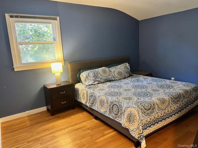 16 Lilac Road Westhampton Beach, NY 11978 - Photo 20 of 25 a bedroom with a bed and window